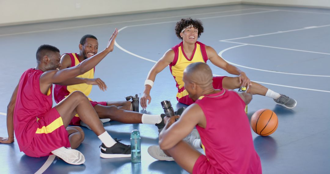 Diverse Basketball Team Relaxing Mid-Game, Sharing Strategies