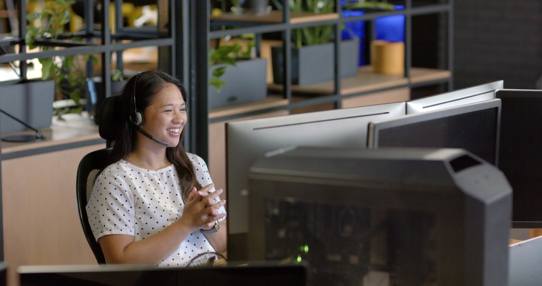 Smiling Woman in Polka Dot Shirt using Headset in Office Environment