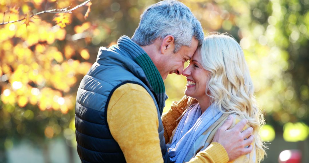 Happy Couple Embracing in Autumn Park - Free Images, Stock Photos and Pictures on Pikwizard.com