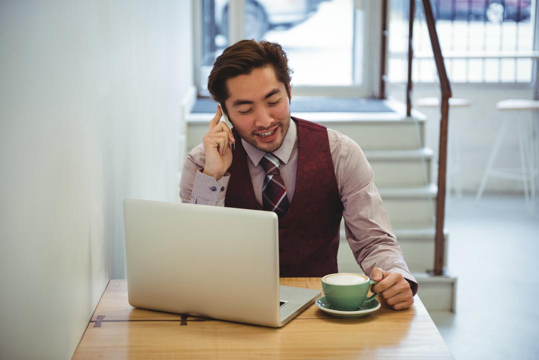 Man talking on mobile phone while having coffee - Tips on how to effectively promote your content - Image