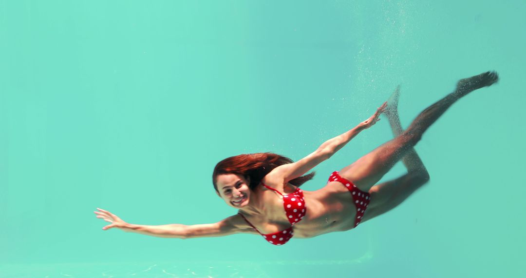 Woman in Red Polka Dot Bikini Swimming Underwater in Pool - Free Images, Stock Photos and Pictures on Pikwizard.com