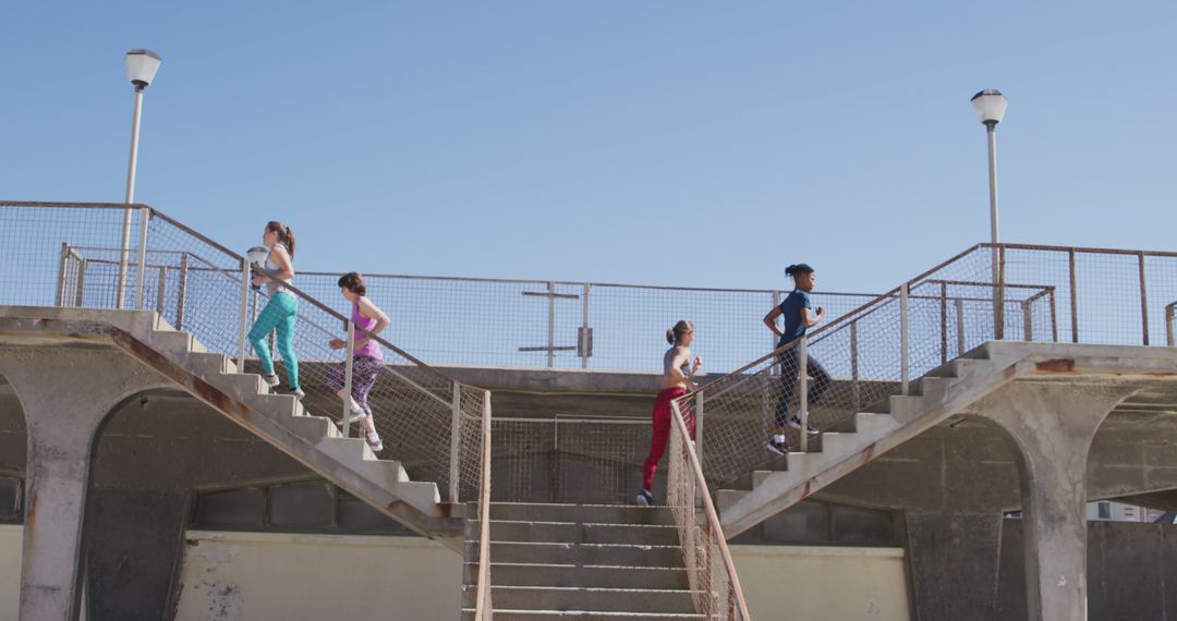 Group of Women Exercising on Outdoor Staircase Under Clear Sky - Free Images, Stock Photos and Pictures on Pikwizard.com