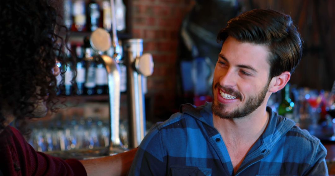 Friends Socializing Cheerfully in a Lively Pub Environment