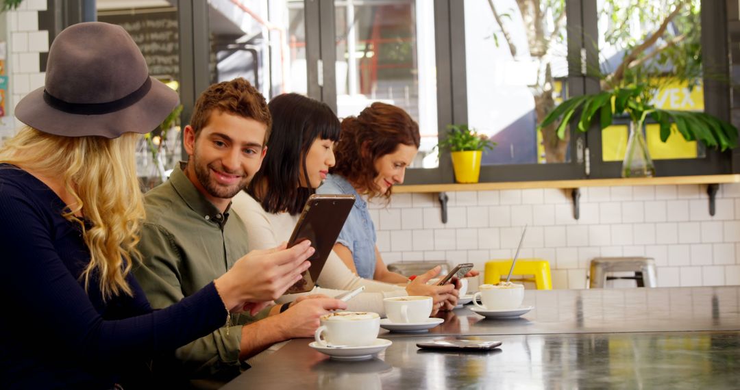 Diverse Young Adults Using Smartphones in Modern Cafe