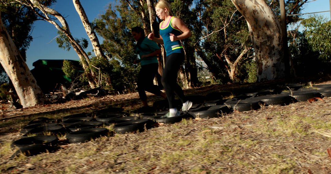 People Engaging in Outdoor Tire Obstacle Training Exercise - Free Images, Stock Photos and Pictures on Pikwizard.com