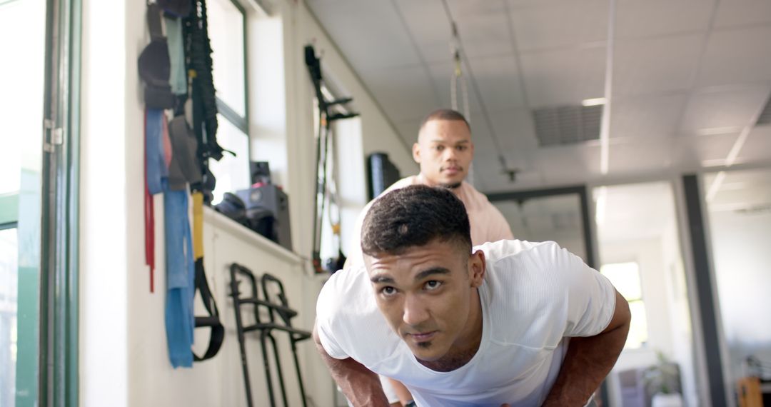 Physical Therapist Assisting Man with Strength Rehabilitation Exercises