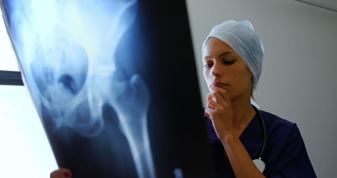 Female Doctor Analyzing X-ray in Hospital - Free Images, Stock Photos and Pictures on Pikwizard.com