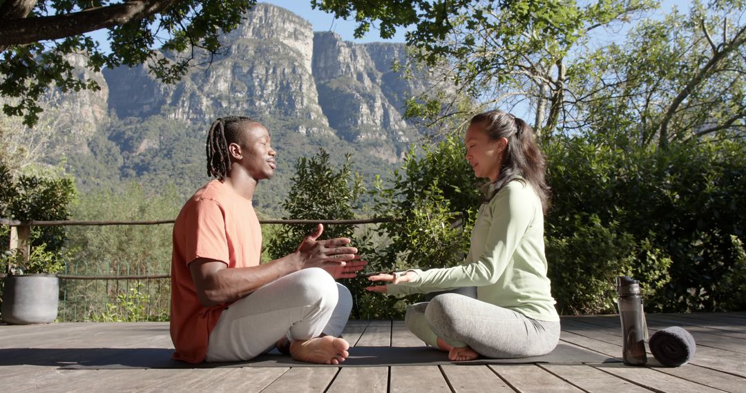 Two People Meditating Outdoors in Scenic Mountain Landscape - Free Images, Stock Photos and Pictures on Pikwizard.com