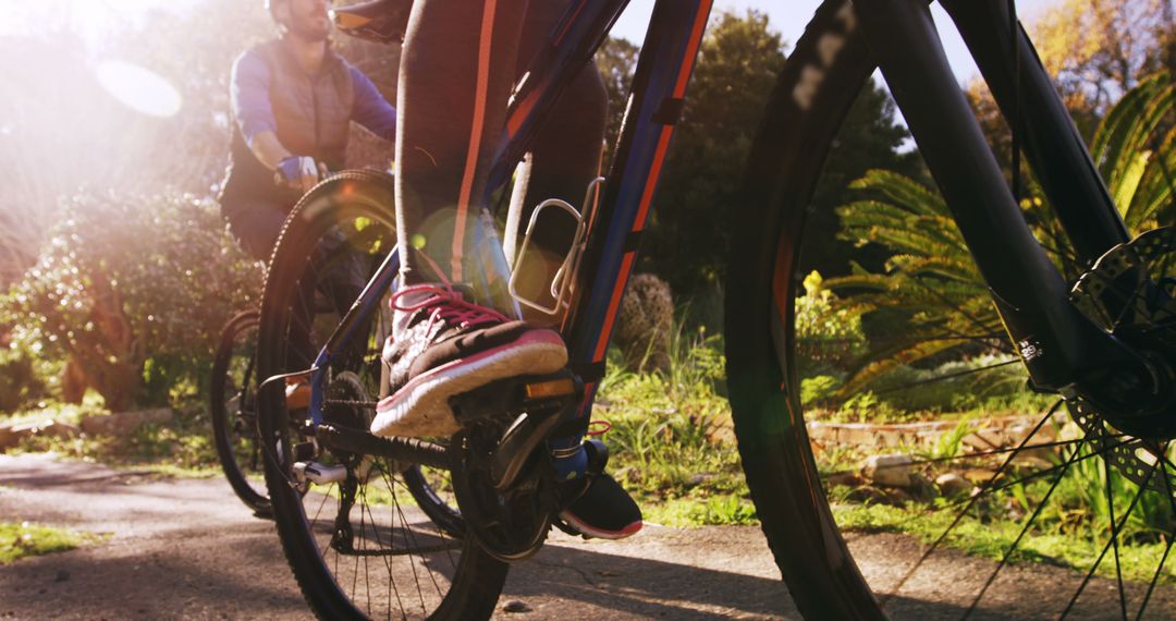 Close-up of Cyclist Riding Bike on Sunny Outdoor Trail - Free Images, Stock Photos and Pictures on Pikwizard.com