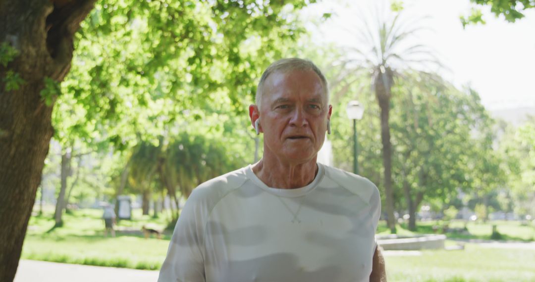 Senior Man Jogging in Park with Tree and Sunshine Background - Free Images, Stock Photos and Pictures on Pikwizard.com