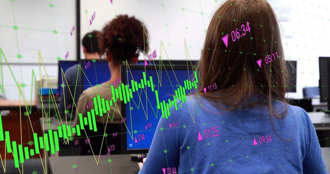 Diverse Team Analyzing Financial Data on Monitors in Office Environment