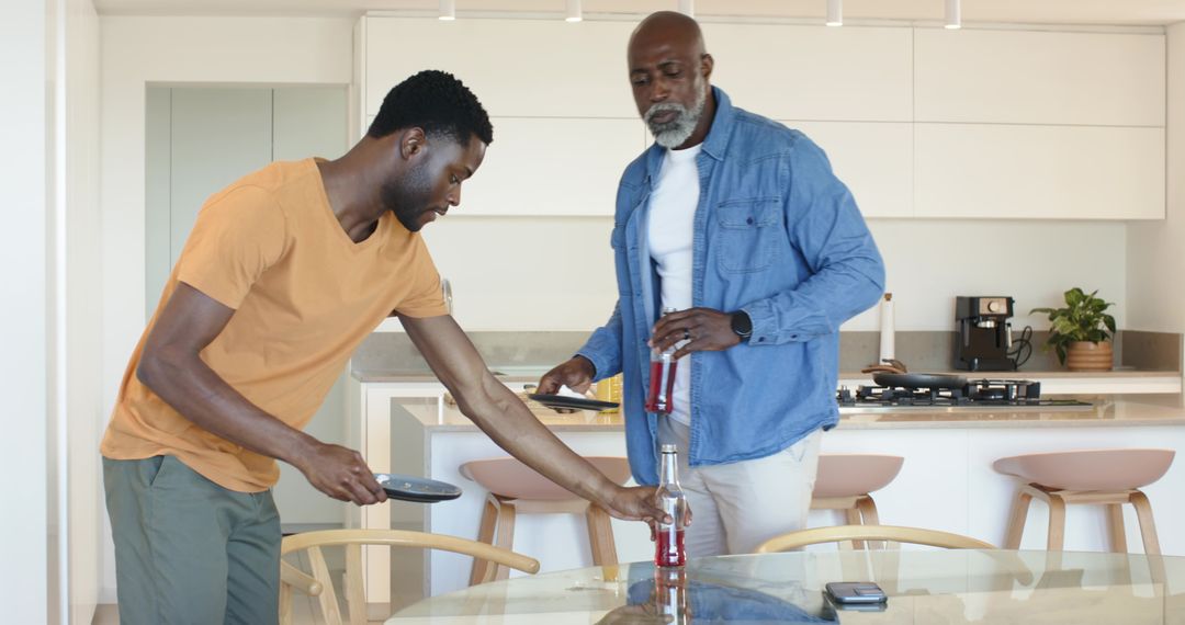 Father and Son Bonding in Modern Kitchen while Sharing a Drink