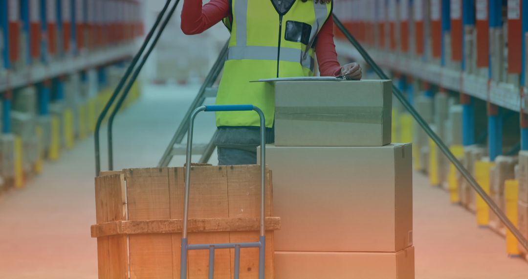 Warehouse Worker Organizing Cargo on Trolley for Distribution