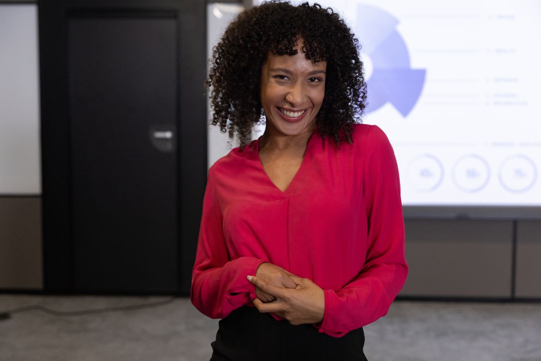 Smiling Professional Presenting Data in Modern Conference Room