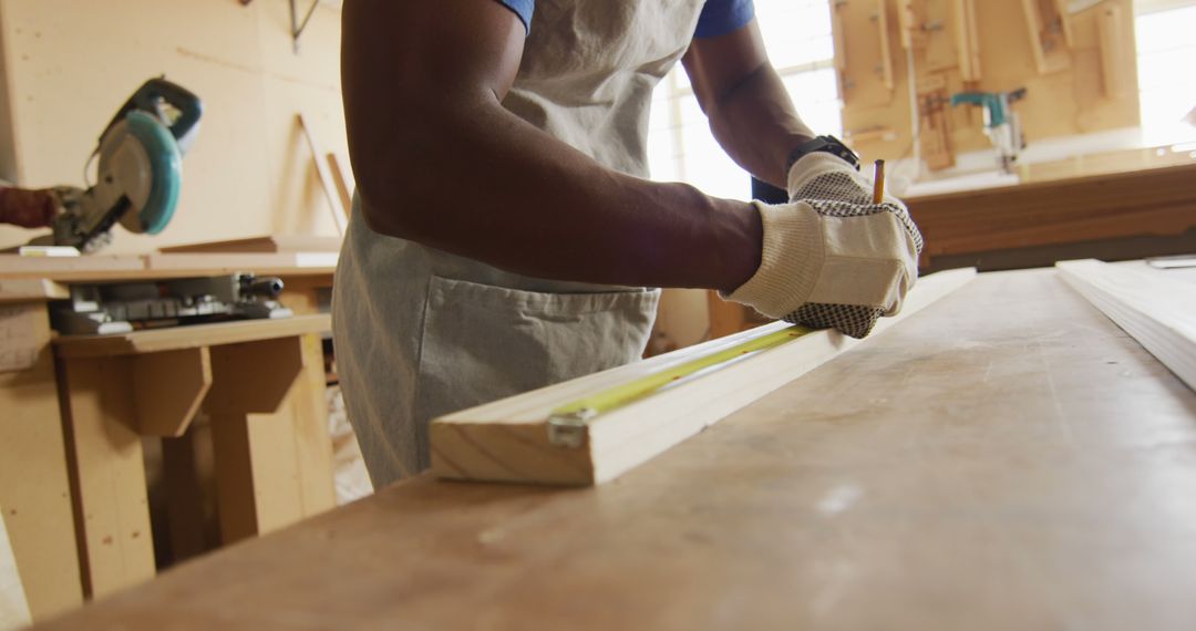 Carpenter Measuring Wood with Tape Measure in Workshop - Free Images, Stock Photos and Pictures on Pikwizard.com