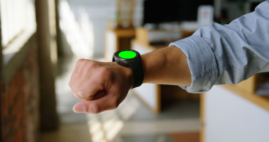 Man Checking Smartwatch With Green Screen Mockup in Office - Free Images, Stock Photos and Pictures on Pikwizard.com