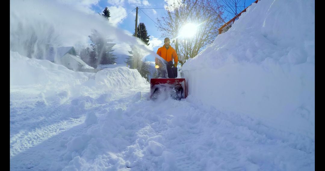 Man Clearing Snow on Sunny Winter Day with Snow Blower - Free Images, Stock Photos and Pictures on Pikwizard.com