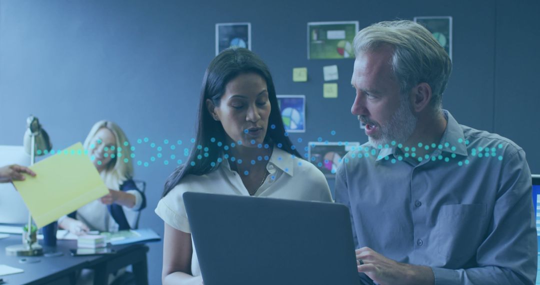 Coworkers Collaborating on Data Analysis in Modern Office