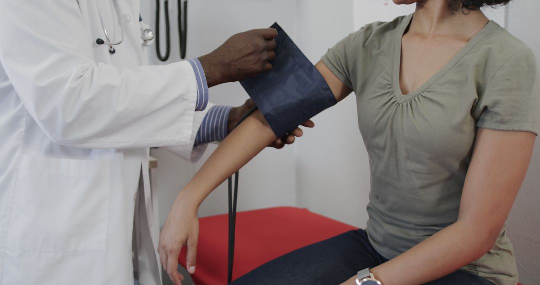 Doctor Monitoring Blood Pressure of Diverse Female Patient in Clinic - Free Images, Stock Photos and Pictures on Pikwizard.com