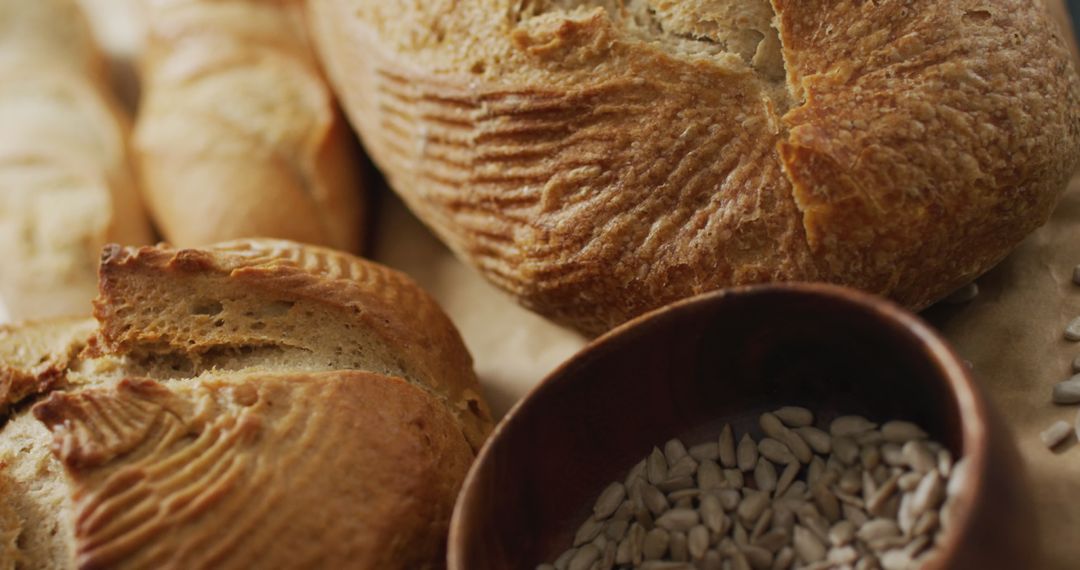 Freshly Baked Artisan Bread with Seeds on Rustic Worktop