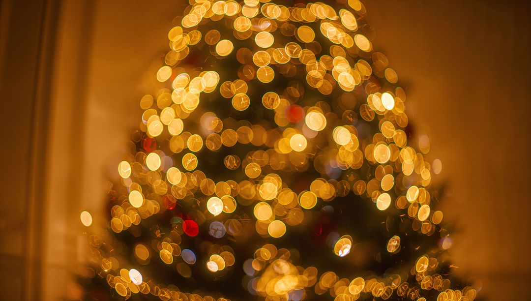 Glowing Christmas Tree Bokeh Lights Creating Cozy Holiday Atmosphere in Living Room Corner