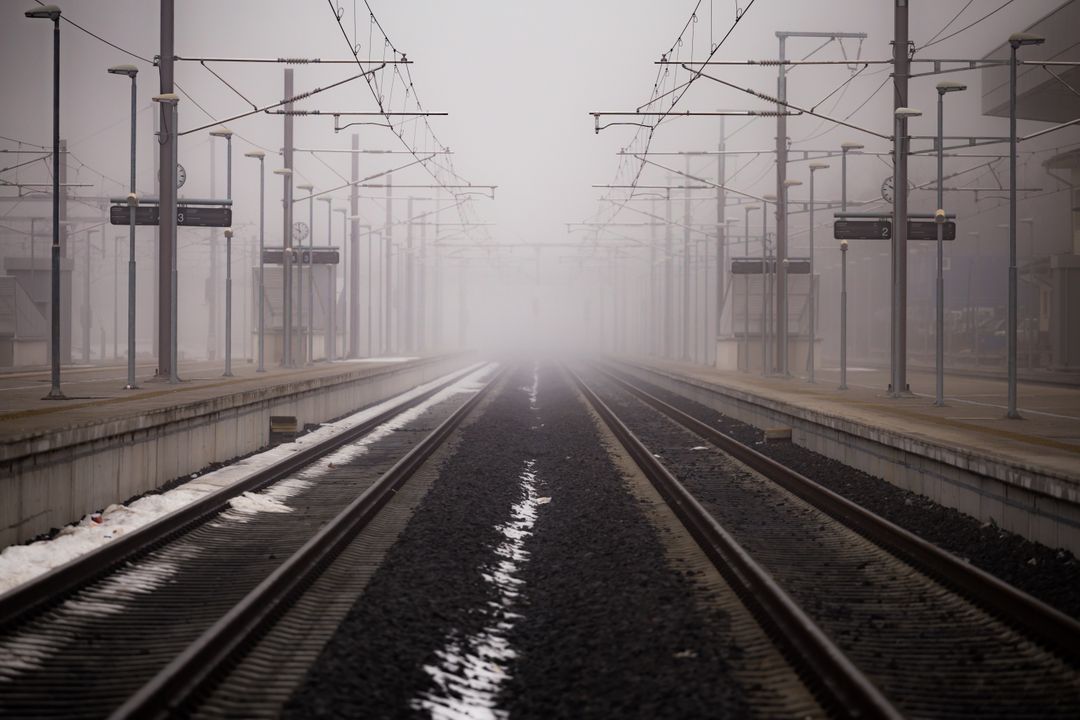 Foggy Train Station with Empty Tracks - Free Images, Stock Photos and Pictures on Pikwizard.com