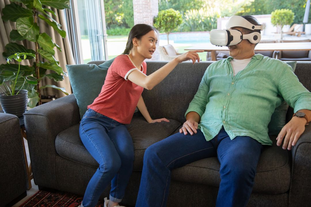 Father and Daughter Exploring Virtual Reality Together at Home