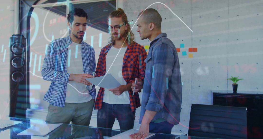 Collaborative Office Meeting Reviewing Documents and Analytics