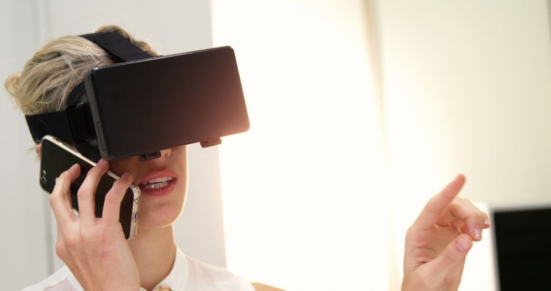 Woman Using Virtual Reality Headset While Talking on Smartphone - Free Images, Stock Photos and Pictures on Pikwizard.com