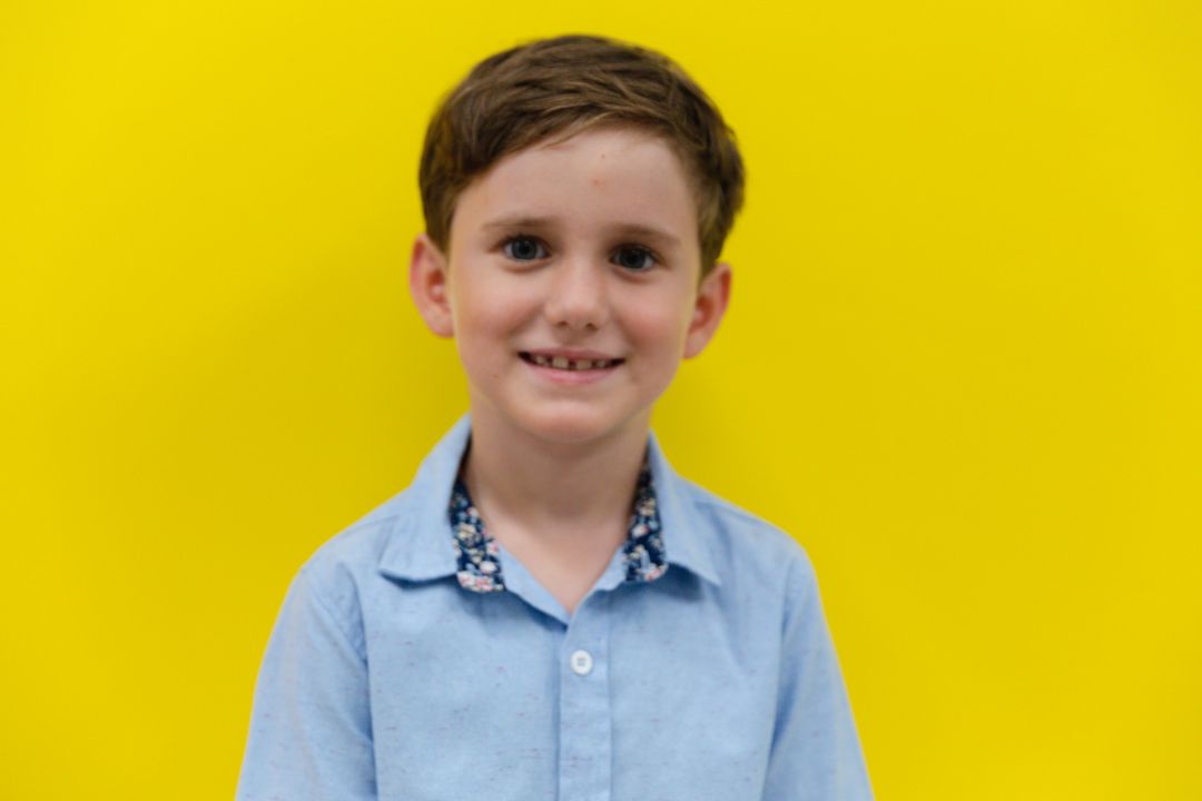 Portrait of smiling cute caucasian elementary schoolboy against vibrant yellow background - Free Images, Stock Photos and Pictures on Pikwizard.com