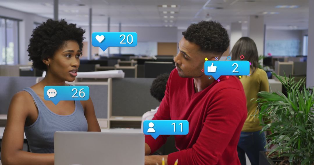 Colleagues Analyzing Social Media Interaction in Modern Office