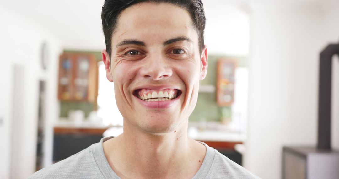 Joyful Man Smiling at Home in Casual Setting