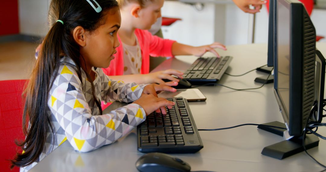 Girls Learning Computer Skills in Classroom
