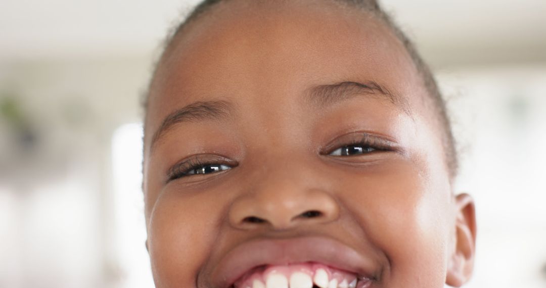 Close-Up of Smiling Child Outdoors on a Sunny Day - Free Images, Stock Photos and Pictures on Pikwizard.com