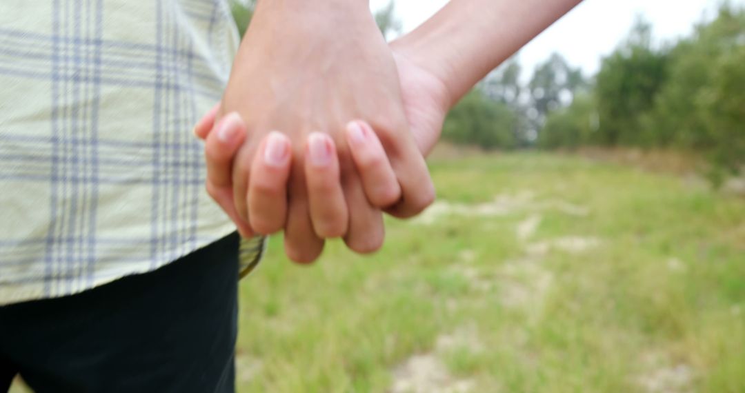 Two people are holding hands, symbolizing friendship or a romantic relationship, with copy space - Free Images, Stock Photos and Pictures on Pikwizard.com