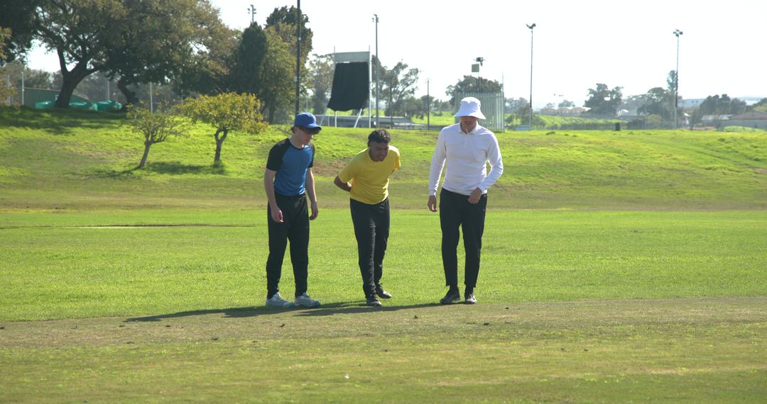 Men Exploring Grass Field on Sunny Day