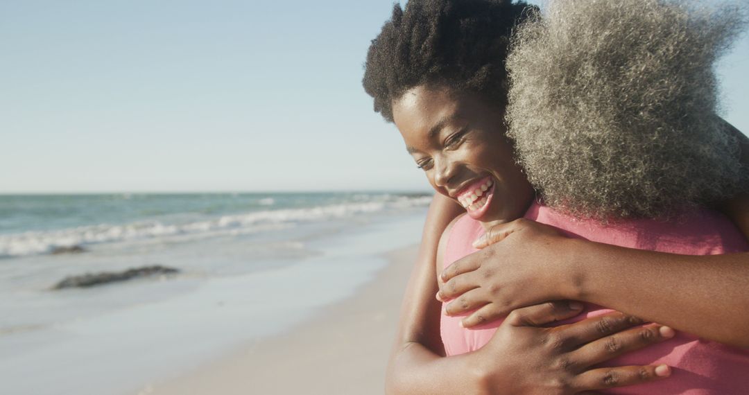 Joyful Embrace on Sandy Beach with Oceanview Background - Free Images, Stock Photos and Pictures on Pikwizard.com