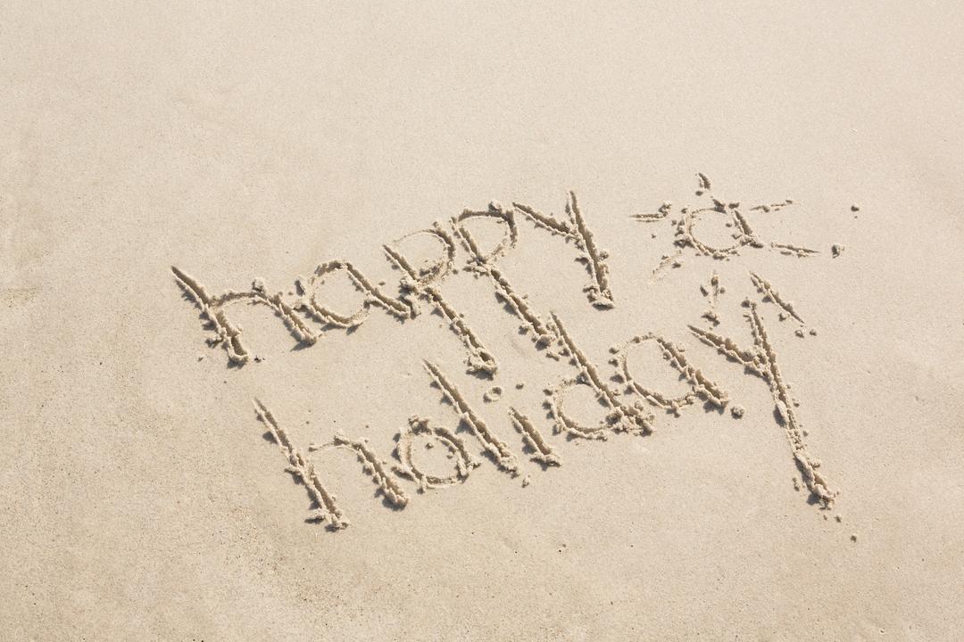 Happy holiday written on sand - Free Images, Stock Photos and Pictures on Pikwizard.com