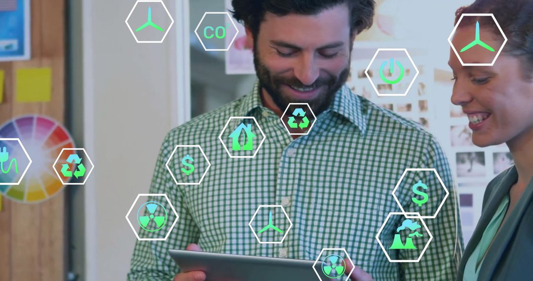 Colleagues Using Digital Tablet with Eco Icons in Modern Office