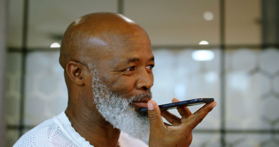 Elderly African American Man Using Voice Command on Smartphone - Free Images, Stock Photos and Pictures on Pikwizard.com