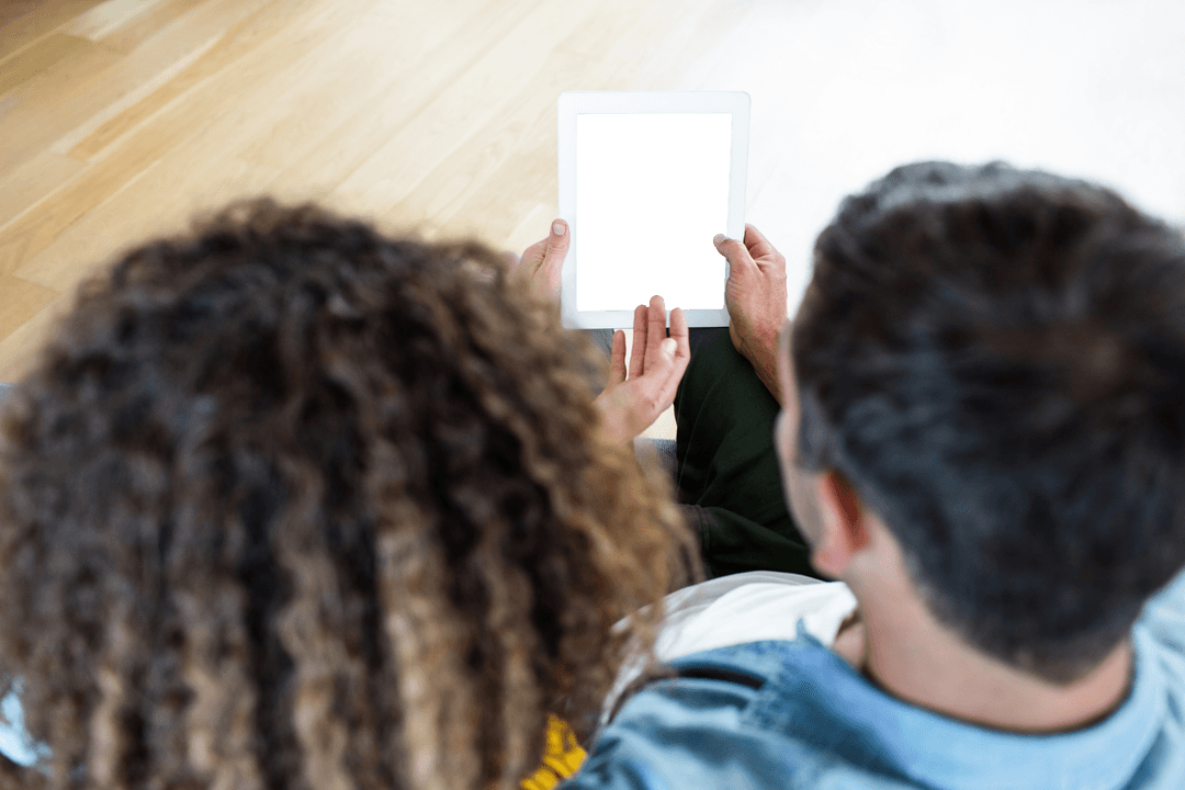 Couple Viewing Transparent Digital Tablet Together Concept