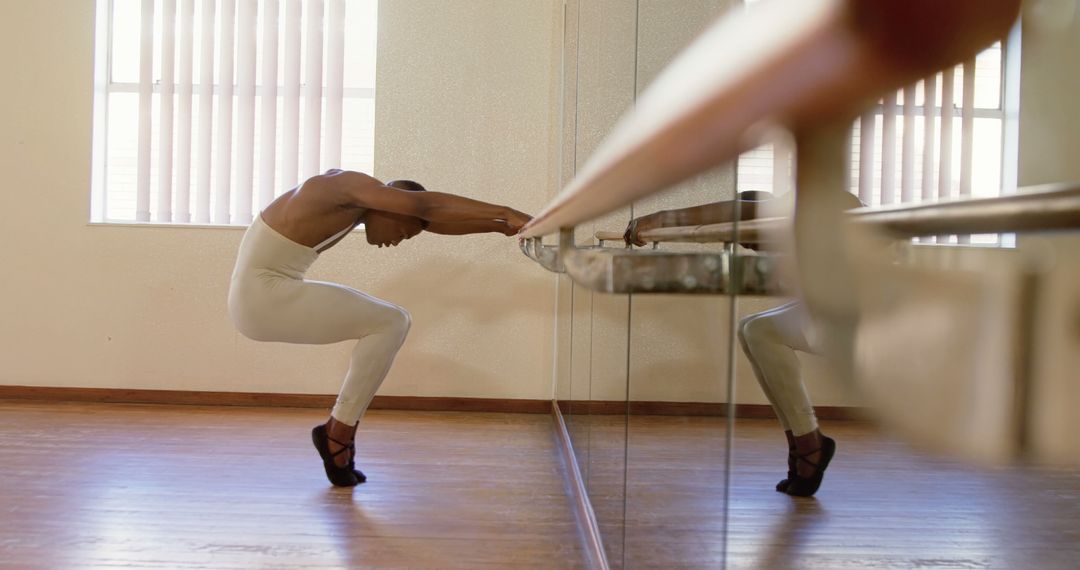 Male Ballet Dancer Stretching at Barre in Dance Studio - Free Images, Stock Photos and Pictures on Pikwizard.com