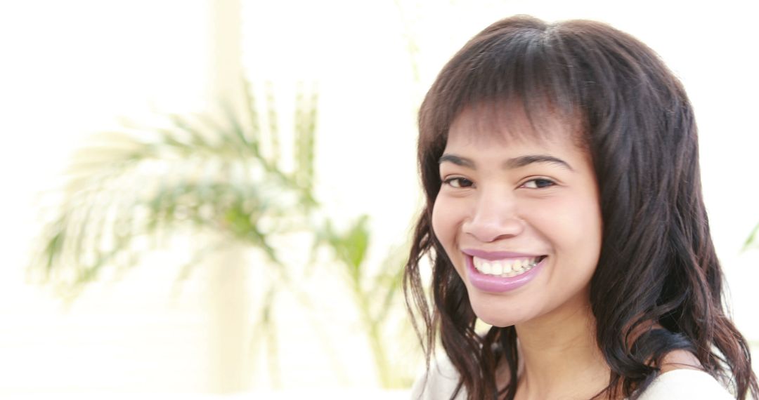 A young Asian woman smiles brightly, with copy space available for text - Free Images, Stock Photos and Pictures on Pikwizard.com