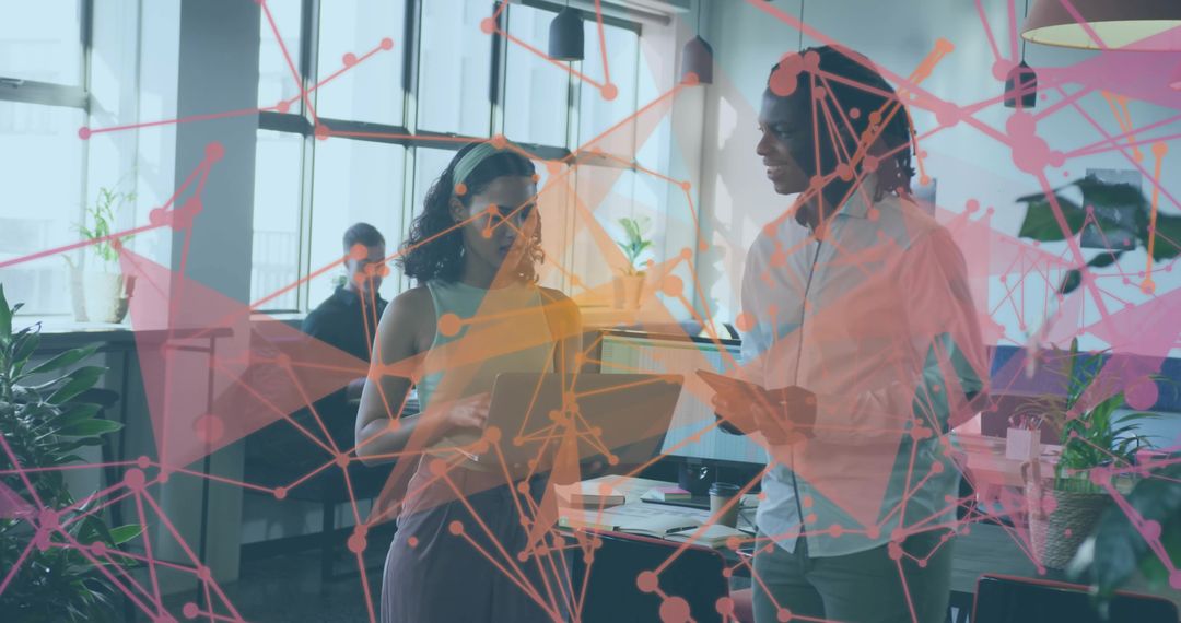 Coworkers Collaborating Over Tablet with Digital Network Overlay in Modern Open-Plan Office