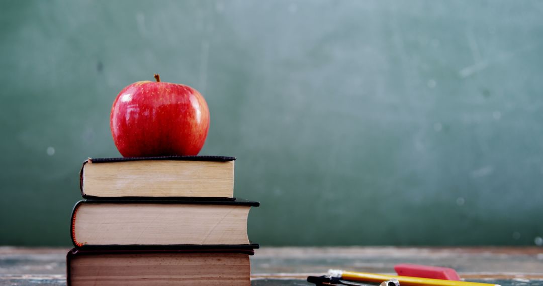 Red Apple on Books with Chalkboard Background for Learning Concept