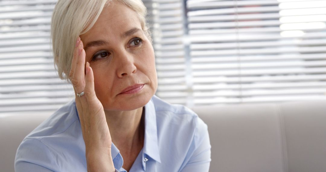 Mature Woman Looking Thoughtful at Office Desk - Free Images, Stock Photos and Pictures on Pikwizard.com