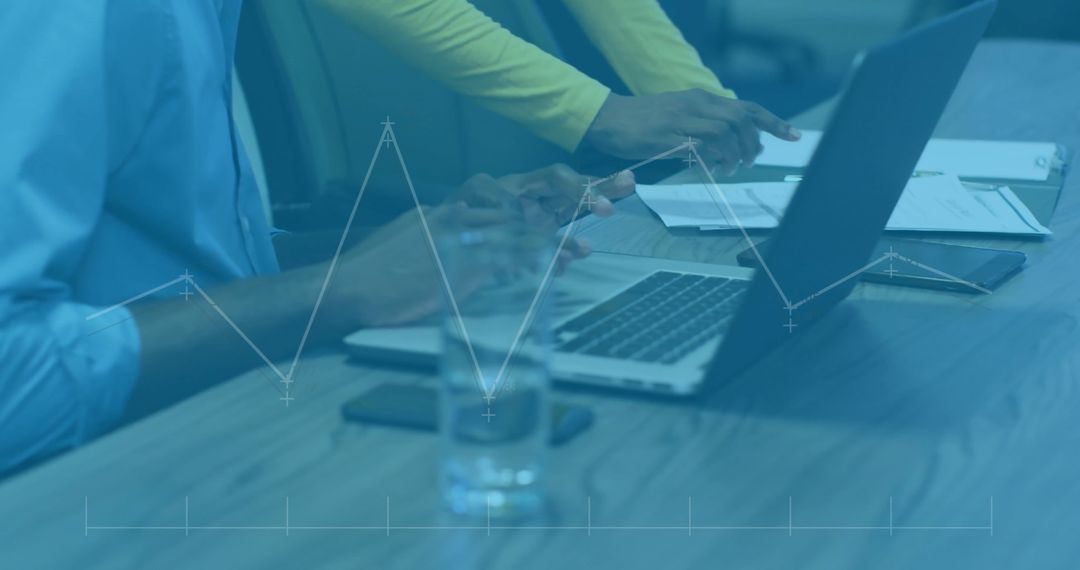 Colleagues Analyzing Financial Data on Laptop in Office Setting