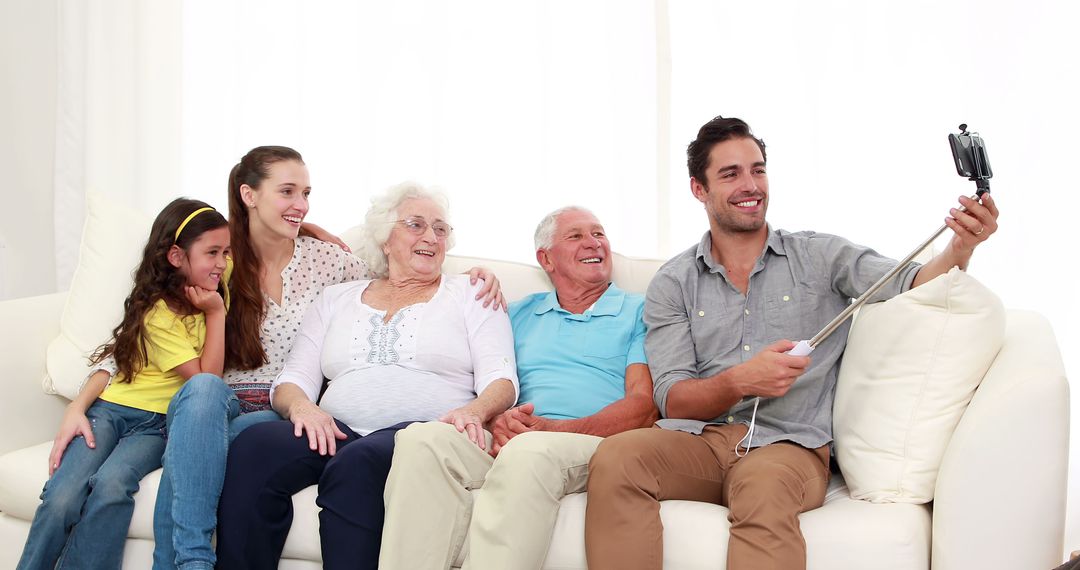 Family Sitting on Couch Taking Group Selfie - Free Images, Stock Photos and Pictures on Pikwizard.com