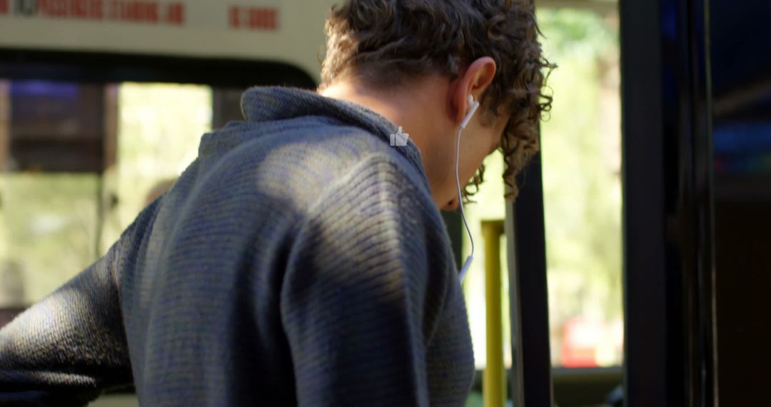 Teen Listening to Music on Bus with Thumbs Up Overlays