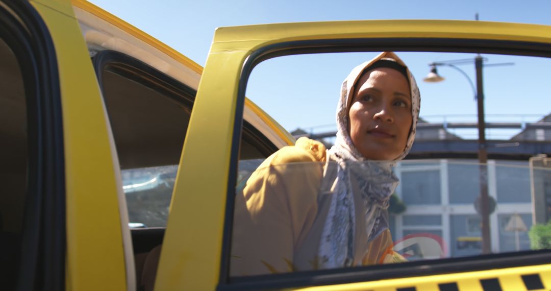 Woman Exiting a Yellow Taxi on Busy Urban Street - Free Images, Stock Photos and Pictures on Pikwizard.com